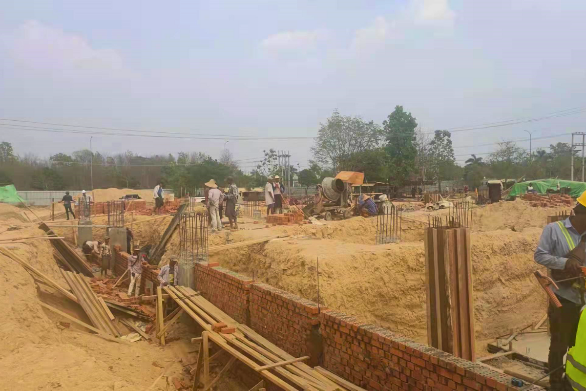 Sub-structure and foundation work at the Emerald E-Commerce Center construction site in Naypyidaw, Myanmar, showing initial ground preparation and concrete pouring.